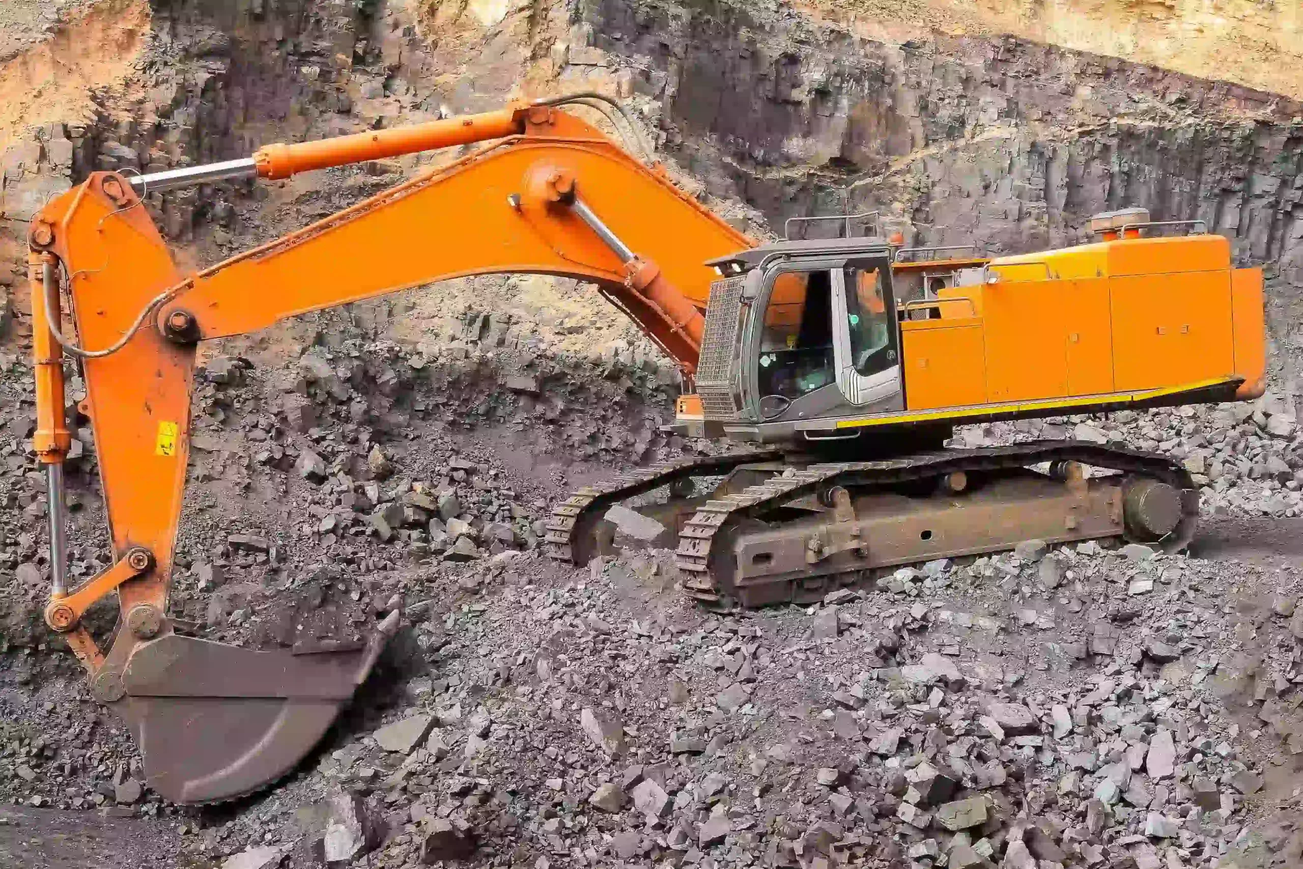 yellow-excavator-digging-ore-rich-rock-open-pit-mine 1