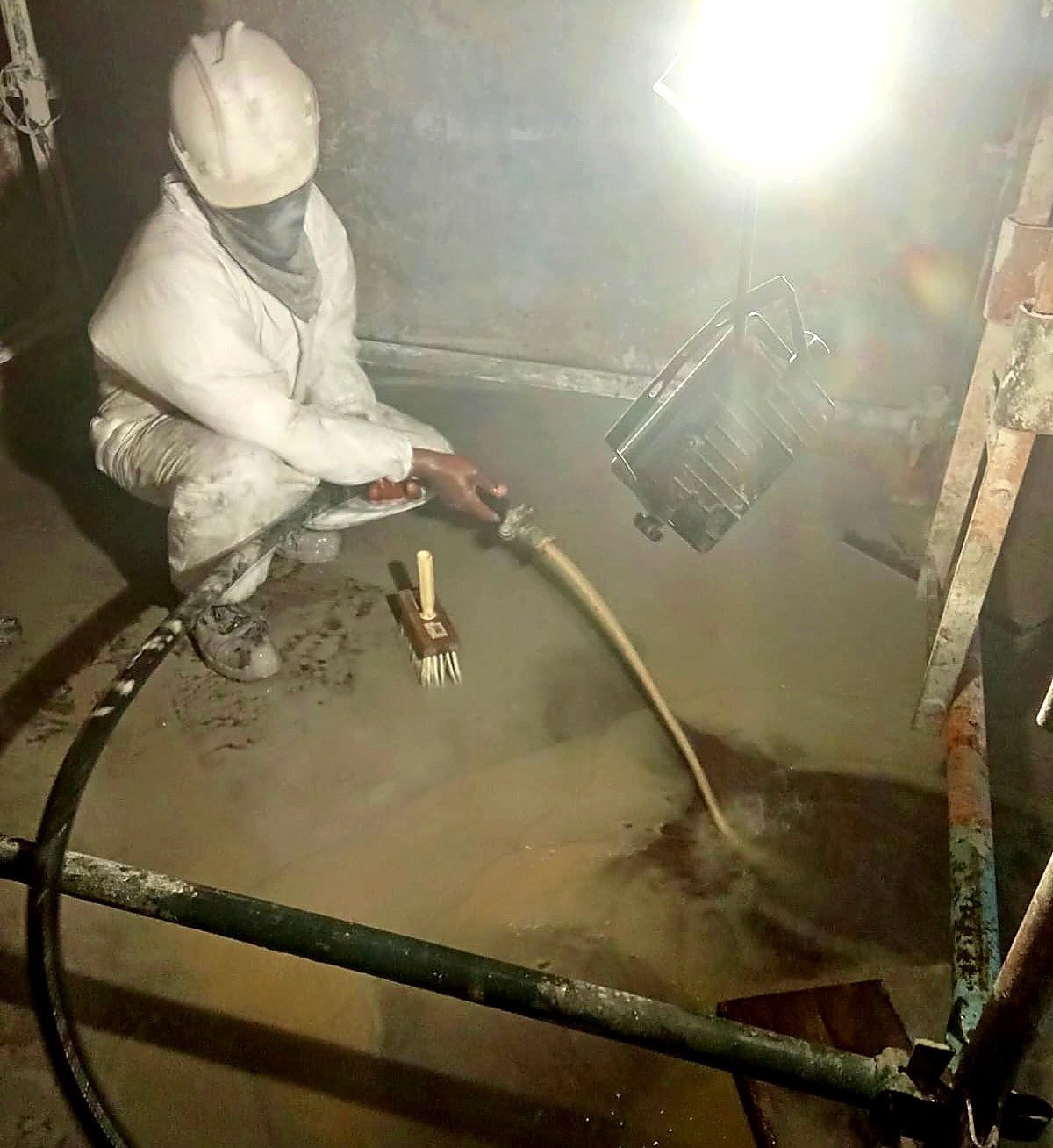 Abrasive blasting the inside of a tank to prepare the surface for lining